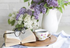 Coffee, book, flowers — Expert Roofing Services in Winnipeg: Ensuring Durable and Reliable Roofs for Your Home