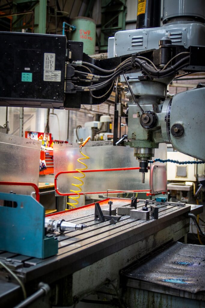 Close-up of a machine tool in an industrial setting, highlighting mechanical components and operational details